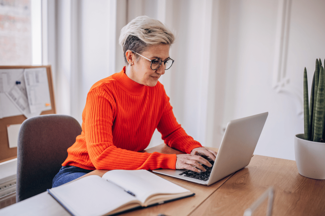Board member at laptop writing minutes