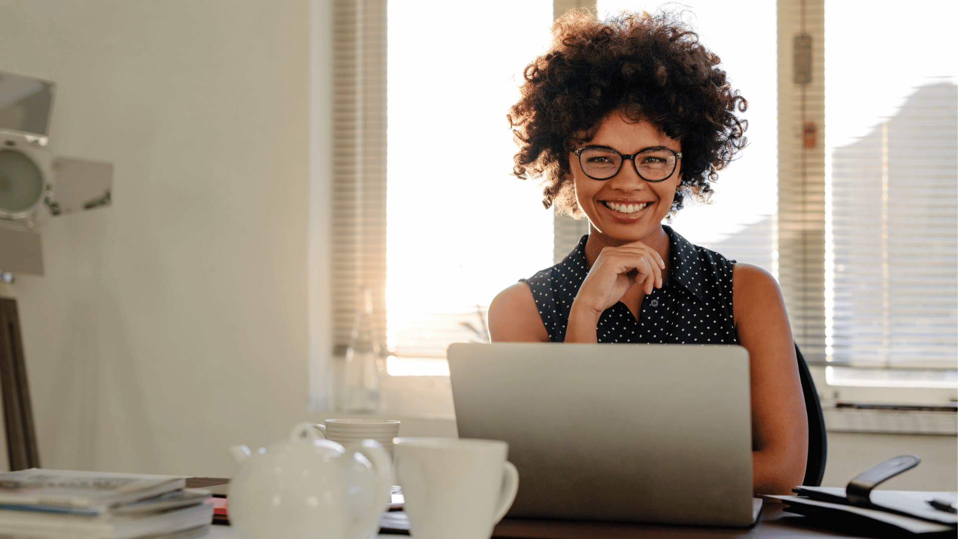 woman working at a laptop on a board agenda