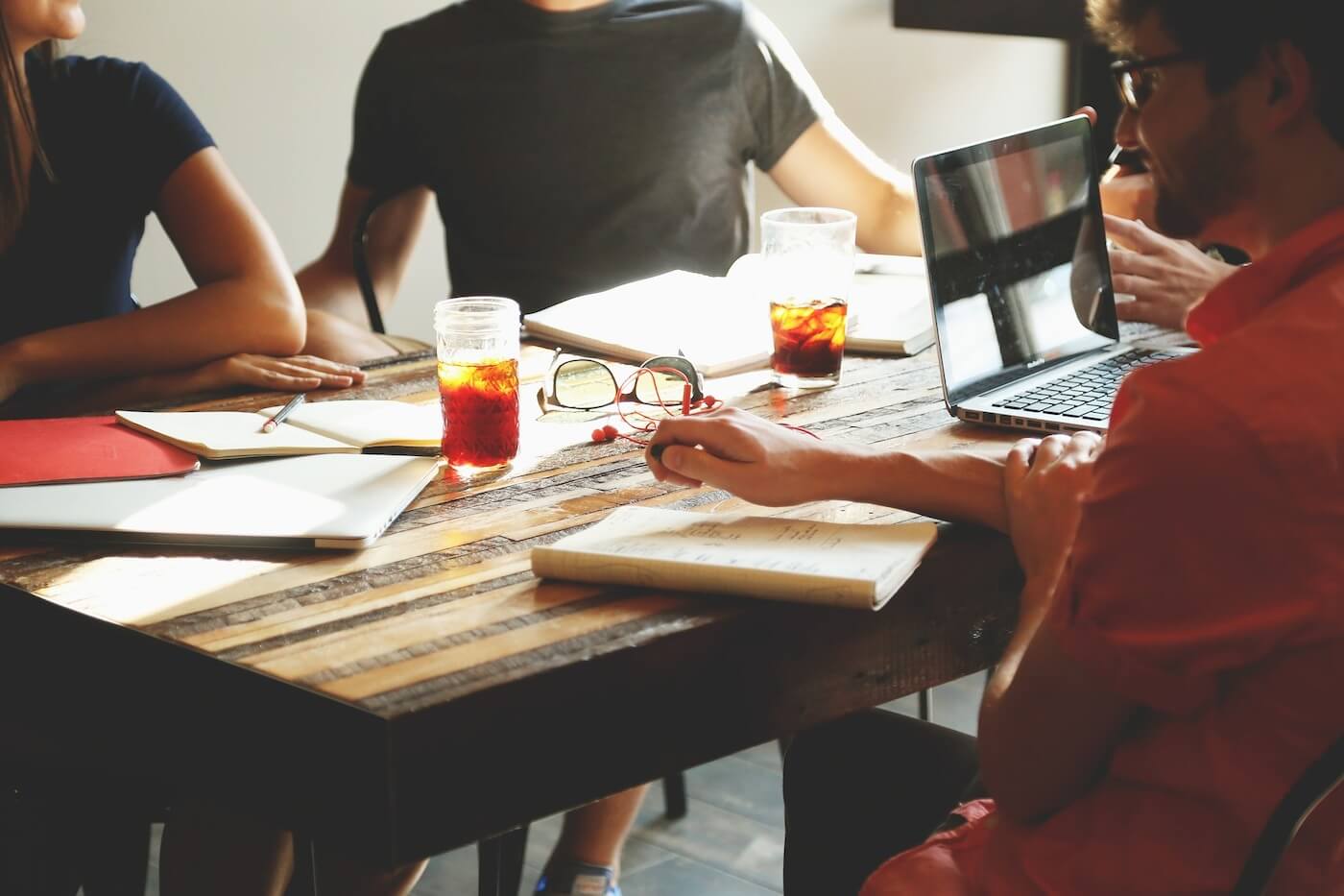 a board table with people writing